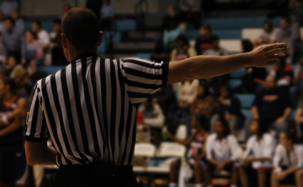 A referee making a call at a basketball game