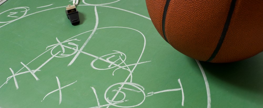 Basketball plays drawn on a chalkboard