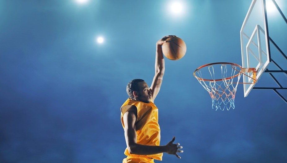 Professional basketball player making a slam dunk